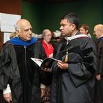 Two faculty members discuss the upcoming ceremony